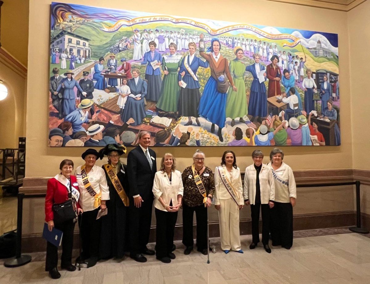 Women pose in front of Phyllis Garibay-Coon's "Rebel Women" mural in the Kansas Statehouse on Jan. 29. (Courtesy photo from AAUW Manhattan.)