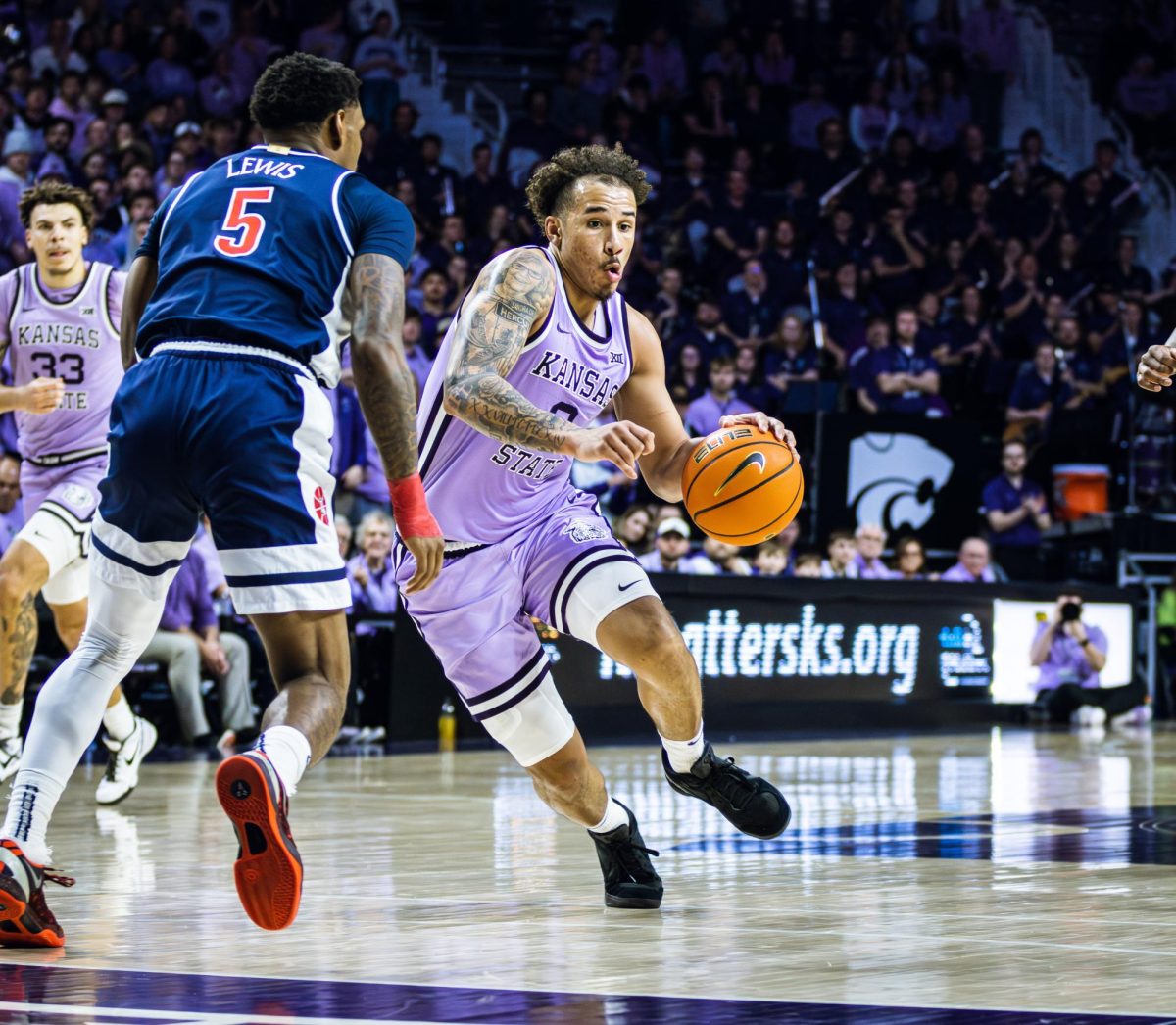 K-State guard Max Jones drives the ball into the lane as the Wildcats (in lavender) defeated Arizona 73-70 on Feb. 11 at Bramlage Coliseum. 

