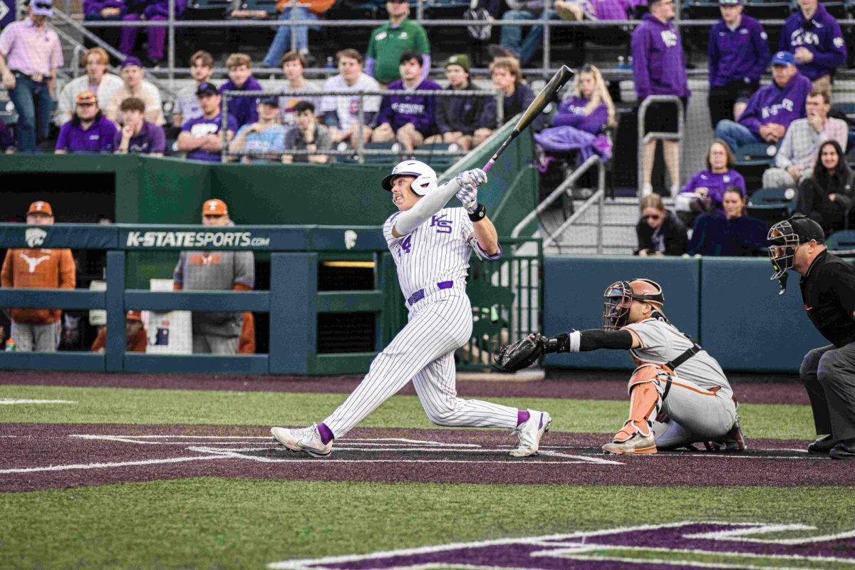 Infielder David Bishop swings for the pitch and hits a home run. The Wildcats defeated Texas 14-6 on March 28, 2024 at Tointon Family Stadium in Manhattan, KS.