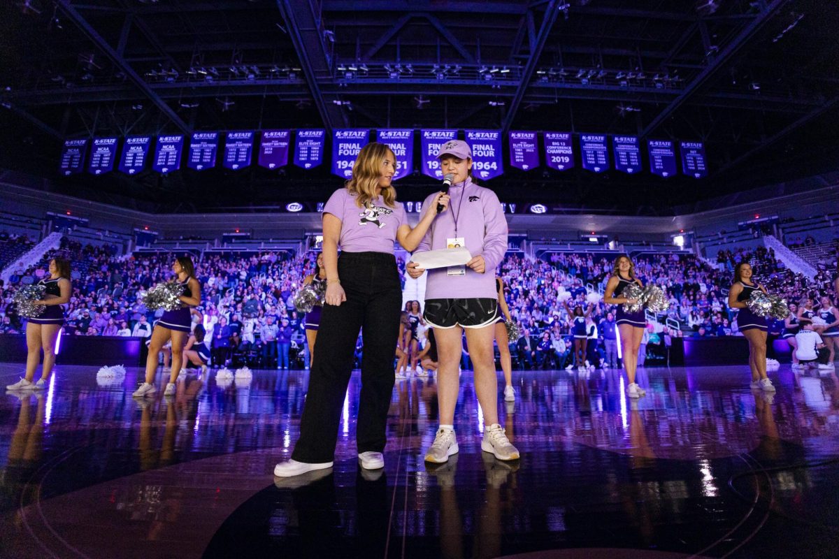 K-State in-game host Keaton Coad helps her National Girls and Women in Sports Day shadow read the pregame player introductions before K-State women's basketball's matchup with UFC on Saturday, Feb. 15. (Photo Courtesy of K-State Athletics)