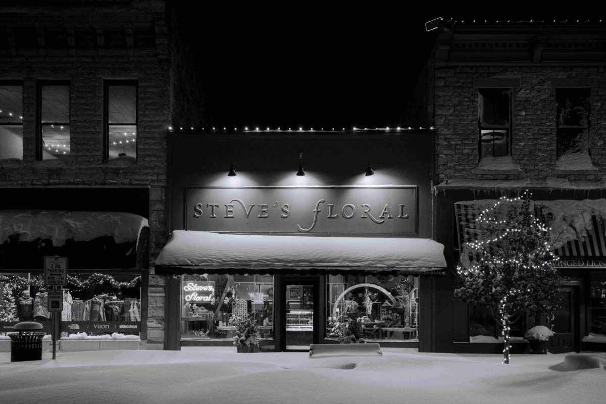 Snow drifts over two feet deep barely leave the benches in front of Steve's Floral visible following the historic snowfall in Manhattan on January 5, 2025.