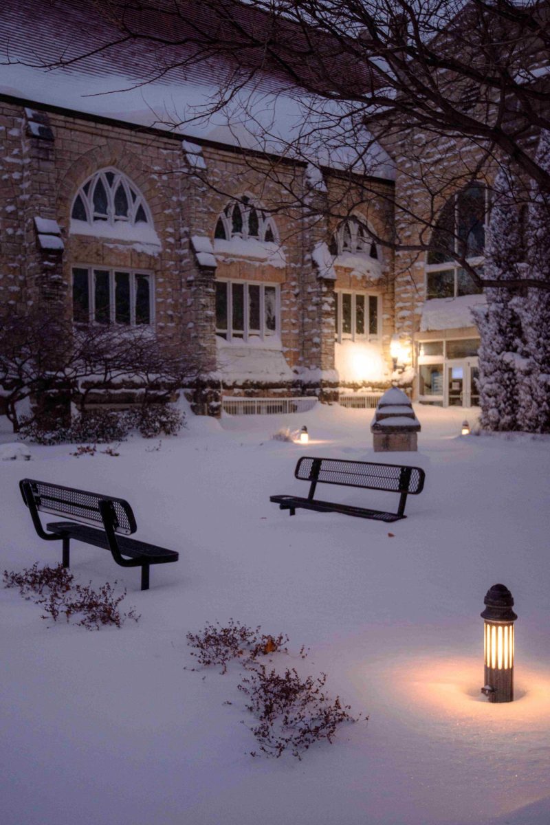 The glow of lamps reflect throughout the snow in a sitting are next to First United Methodist Church of Manhattan, KS on January 5, 2025.