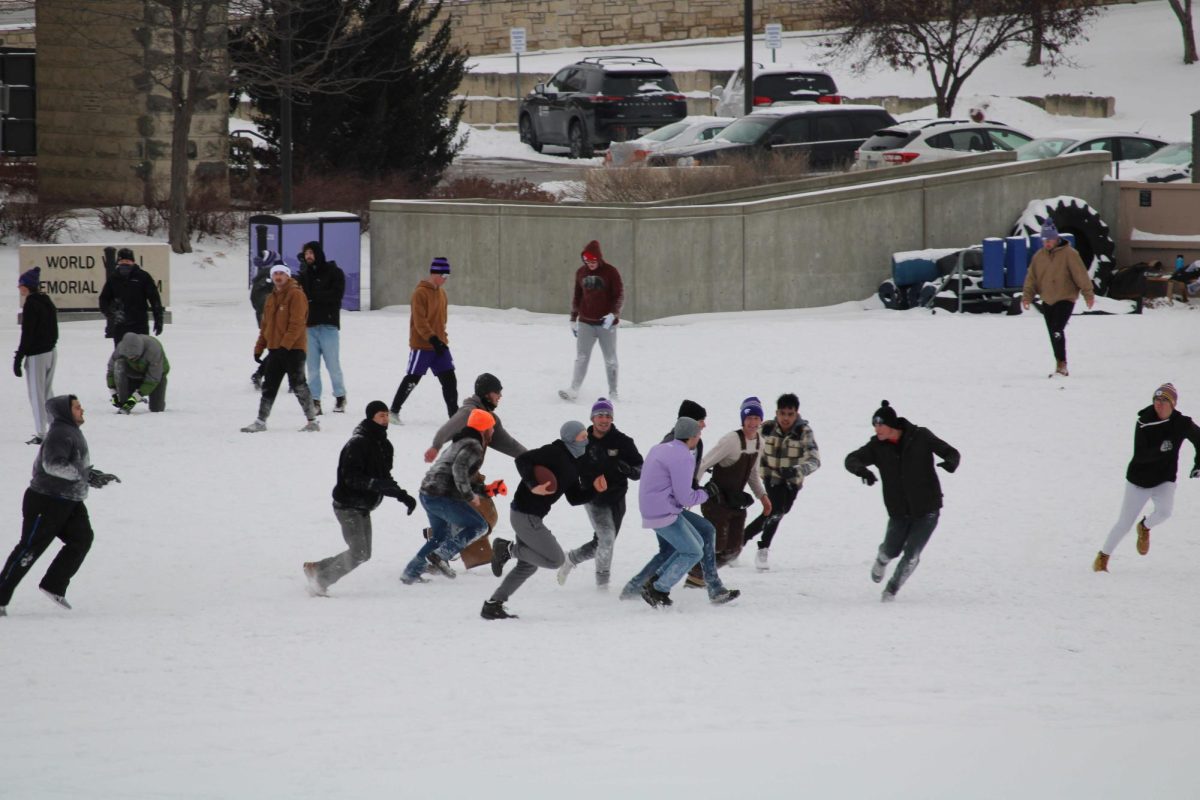 A group of students play tackle football in Memorial stadium on Wednesday, Feb. 12.