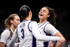 Guards Jaelyn Glenn (3) and Zyanna Walker (1) celebrate with a chest bump after Glenn drew a critical and-1 during the UCF game at the Big XII Tournament on March 6, 2025.