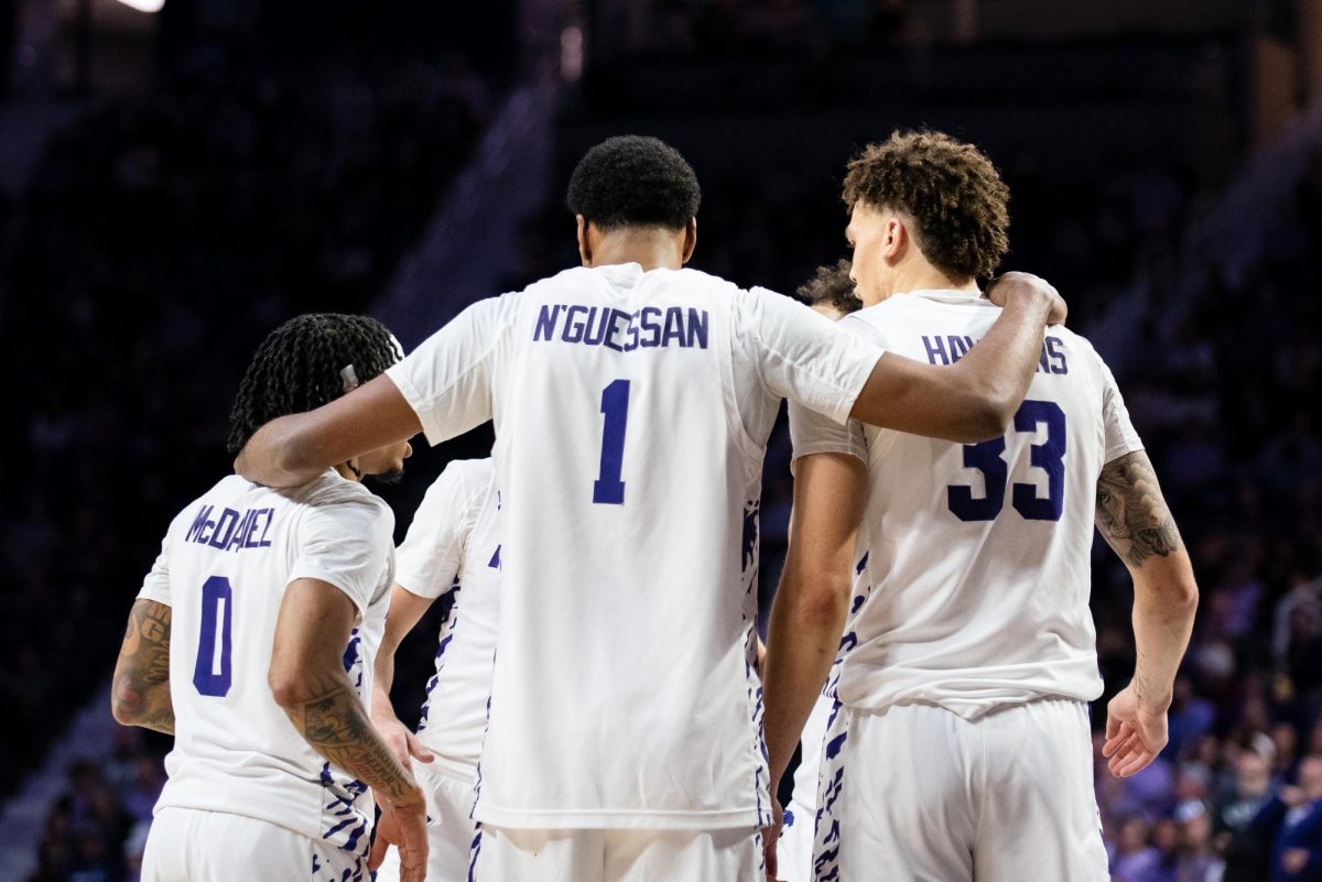 Players Dug McDaniel (0), David N'Guessan (1), and Coleman Hawkins (33) huddle with their teammates during a break in play against the Oklahoma State Cowboys on Jan 29. The Wildcats defeated the Cowboys, 85-57.


