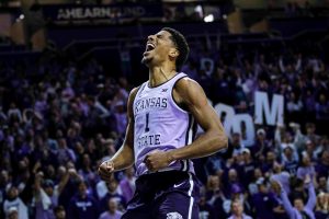 David N'Guessan yells with excitement after dunking the ball. The Wildcats defeated West Virginia 73-60 on Jan. 25 at Bramlage Coliseum. 