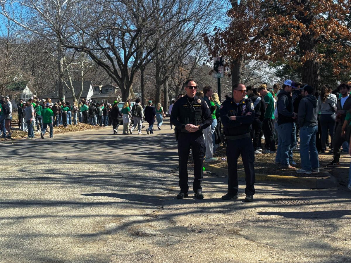 Police monitor the hectic Ratone Street,  as people gather and partake in Fake Patty’s Day festivities.