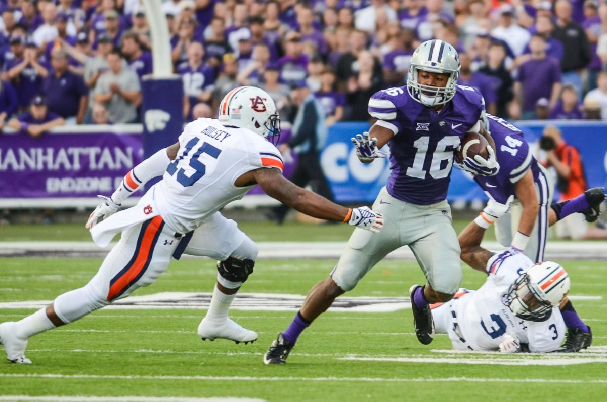 Wide receiver Tyler Lockett evades Auburn defender Joshua Holsey after making a catch during the Wildcats’ 20-14 loss to Auburn on Aug. 18, 2014 in Bill Snyder Family Stadium.