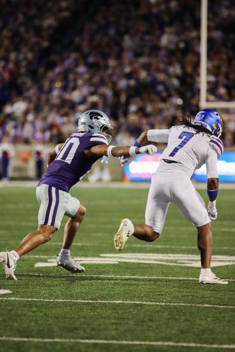 Cornerback Jacob Parish pushes toward KU player during 2024 Sunflower Showdown.