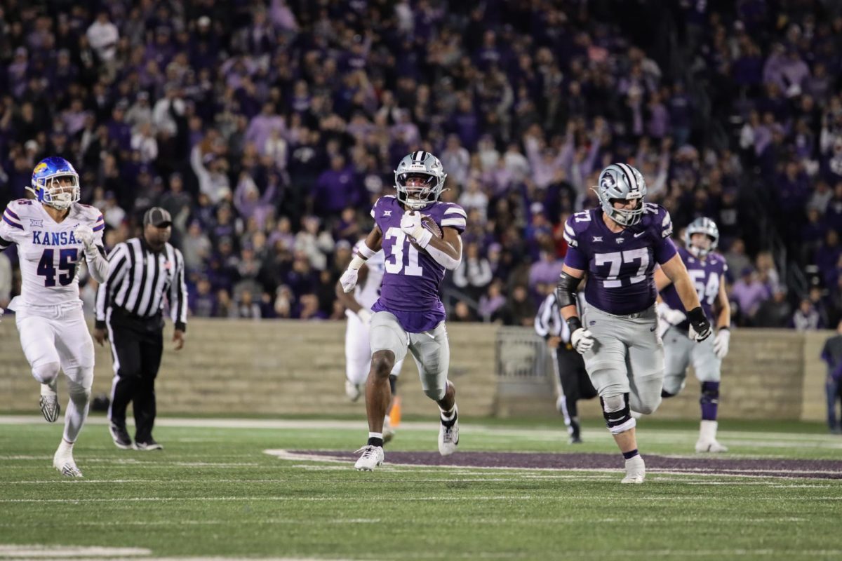 DJ Giddens runs the ball down the field during the 2024 Sunflower Showdown on Oct. 26. The Wildcats defeated Kansas 29-27. (Archive Photo by Grace Parks | Collegian Media Group)
