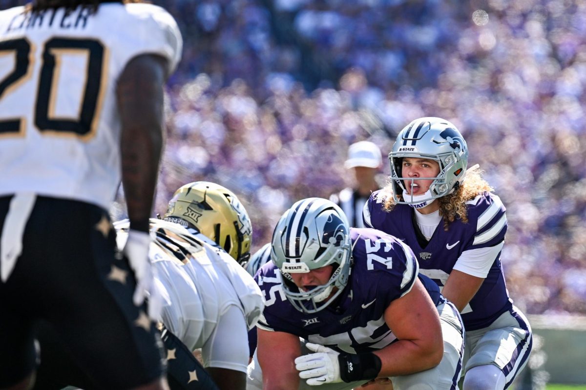 Quarterback Avery Johnson stares down UCF defensive player before the snap.  K-State took down the Knights 34-20 on Sept. 27.