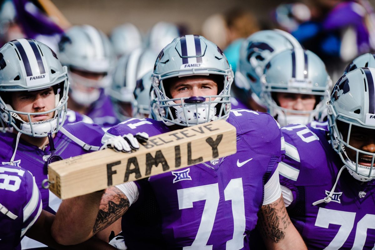 Offensive lineman Dalton Risner holds the family block, prepared to bolt out before the start of the K-State football game against Oklahoma State in Bill Snyder Family Stadium on Oct. 13, 2018. The Wildcats defeated the Cowboys 31-12. (Archive Photo by Meg Shearer | Collegian Media Group)