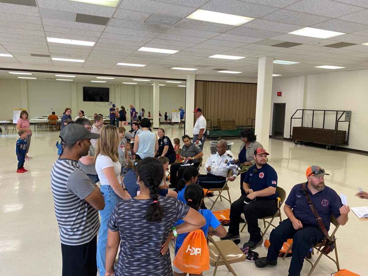In honor of the 9/11 tragedy, first responders assist in giving away shoes to those in need in the Manhattan community. (Photo Courtesy of the Flint Hills Volunteer Center)