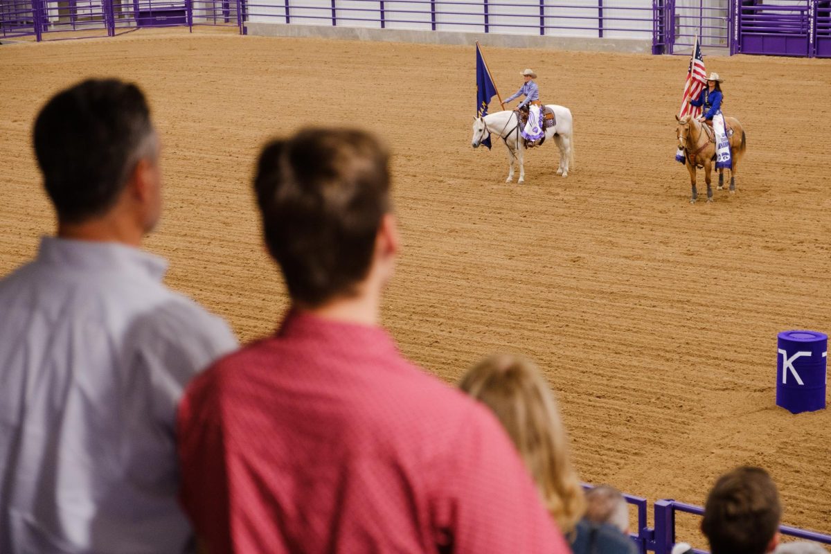 Fans stand in attention during the singing of the National Anthem during open ceremonies for the Bilbrey Family Event Center on Oct. 10.