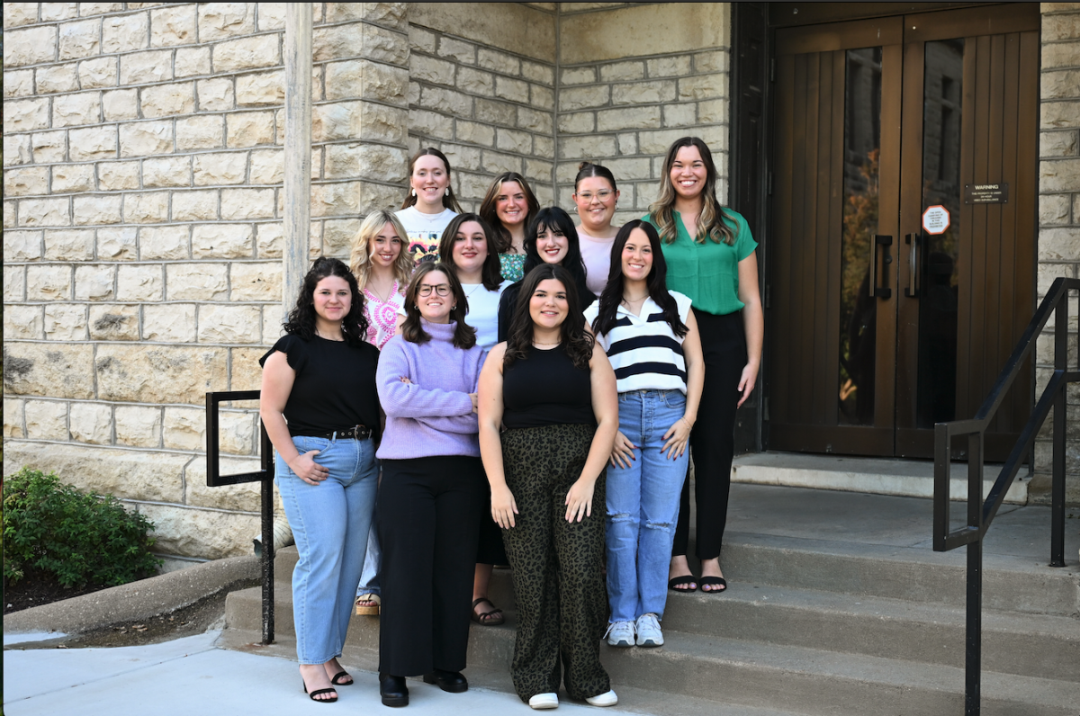 Members of The Collegian Editorial Board pose for photo outside of Kedzie Hall. 