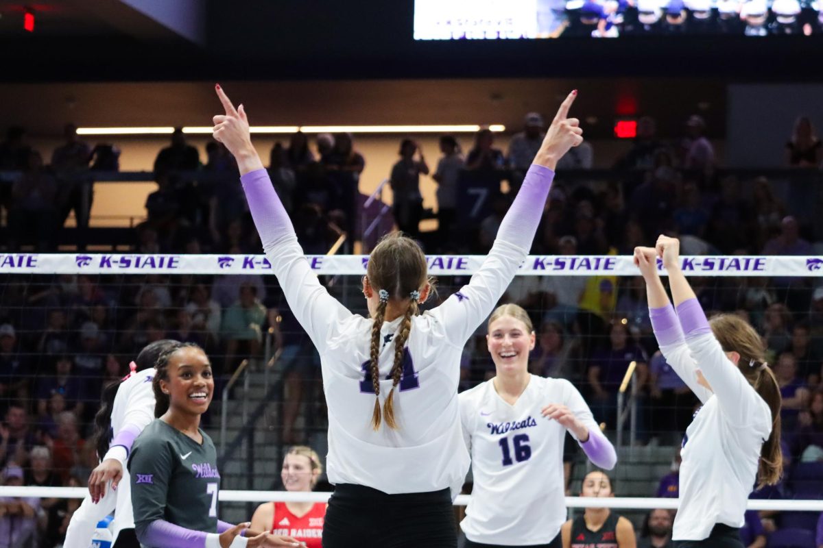 Shaylee Myers celebrates with her teammates after winning a volley. The Wildcats defeated Texas Tech 3-0 on Oct. 10.