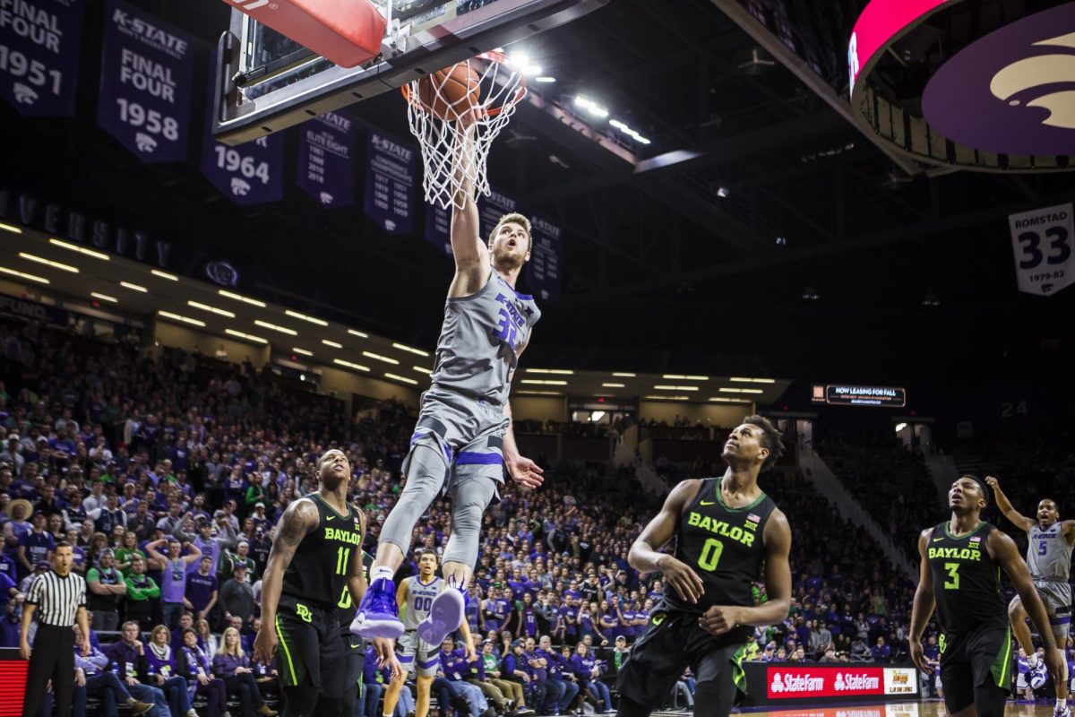 Senior forward Dean Wade slams down a dunk during K-State's basketball game against Baylor in Bramlage Coliseum on March 2, 2019. The Wildcats took the Bears 66-60. (Archive photo by Logan Wassall | Collegian Media Group)