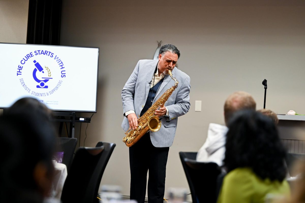 Keynote speaker Nate McClendon begins his presentation with a jazz rendition of "Somewhere Over the Rainbow."
