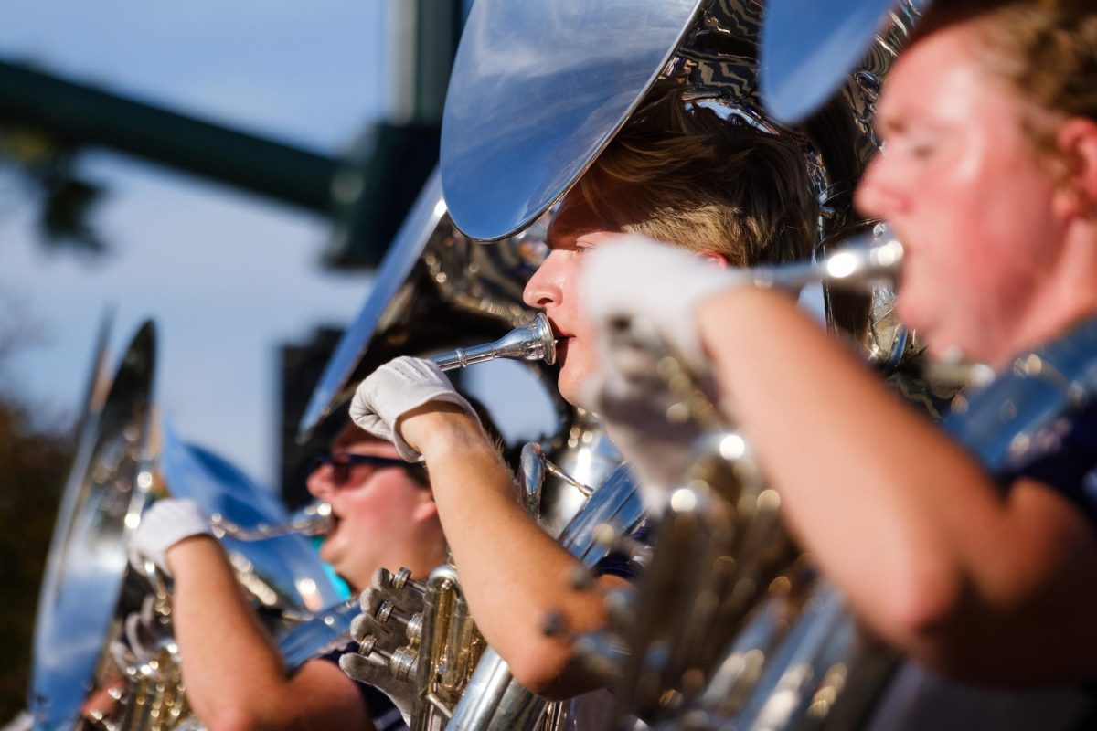 Members of the sousaphone section in the Pride of Wildcat Marching Band play. The band led the parade with renditions of the Fight Song and other K-State classics.