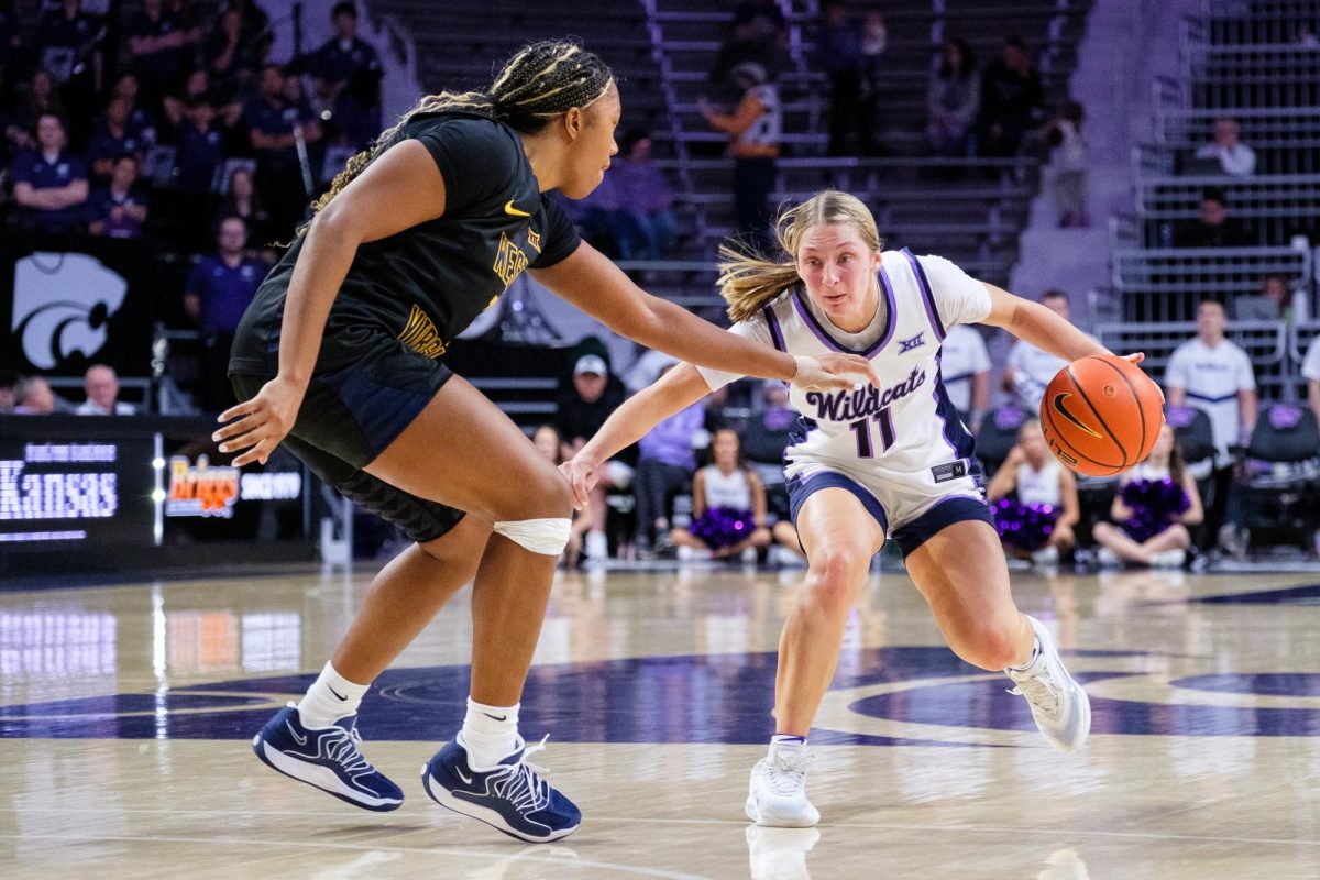 Guard Taryn Sides (11) generates space from a West Virginia defender during the January 4, 2026 game at Bramlage Coliseum.