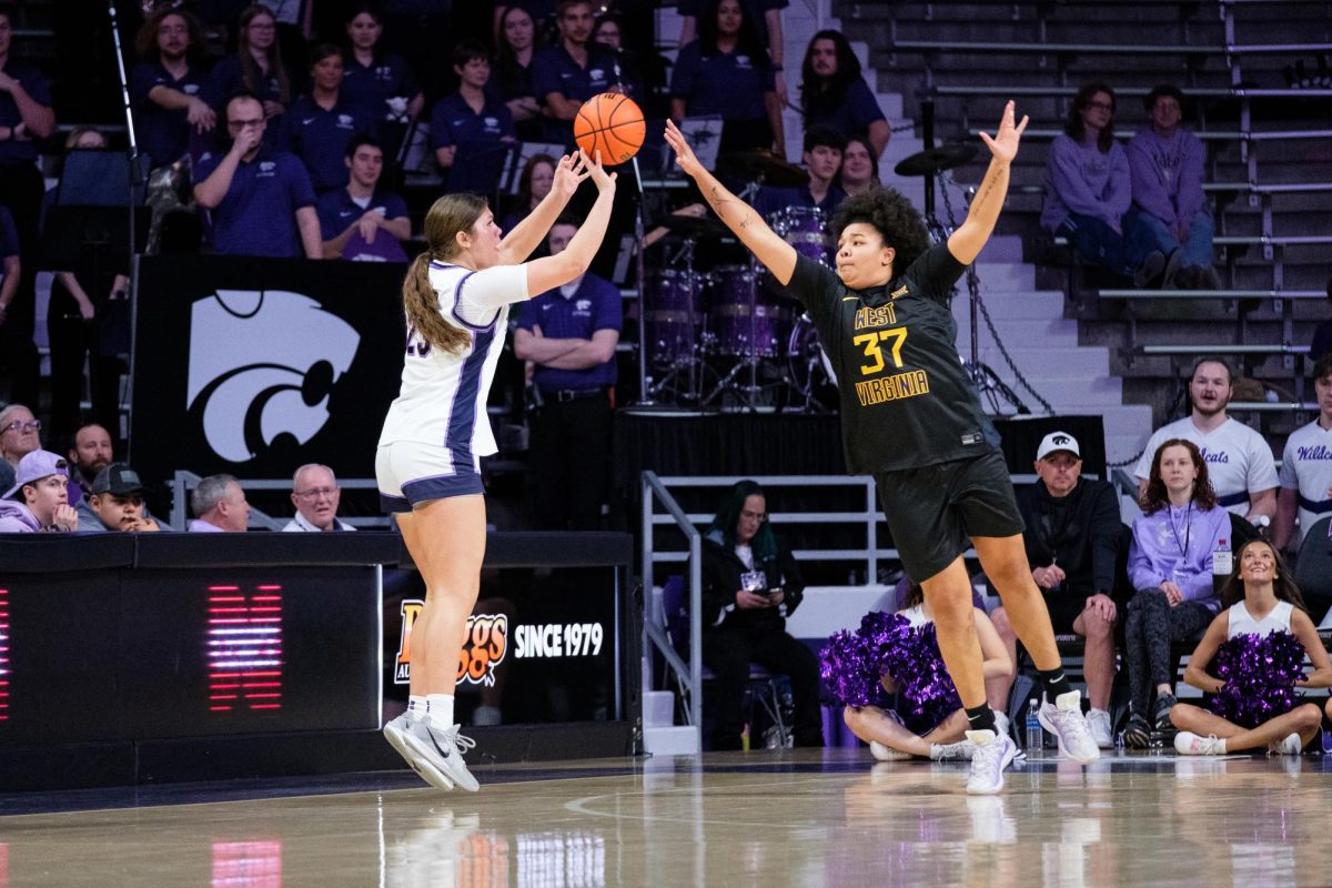 Guard Jordan Speiser (23) fires off a challenged three pointer over a West Virginia defender on January 4, 2026 at Bramlage Coliseum.