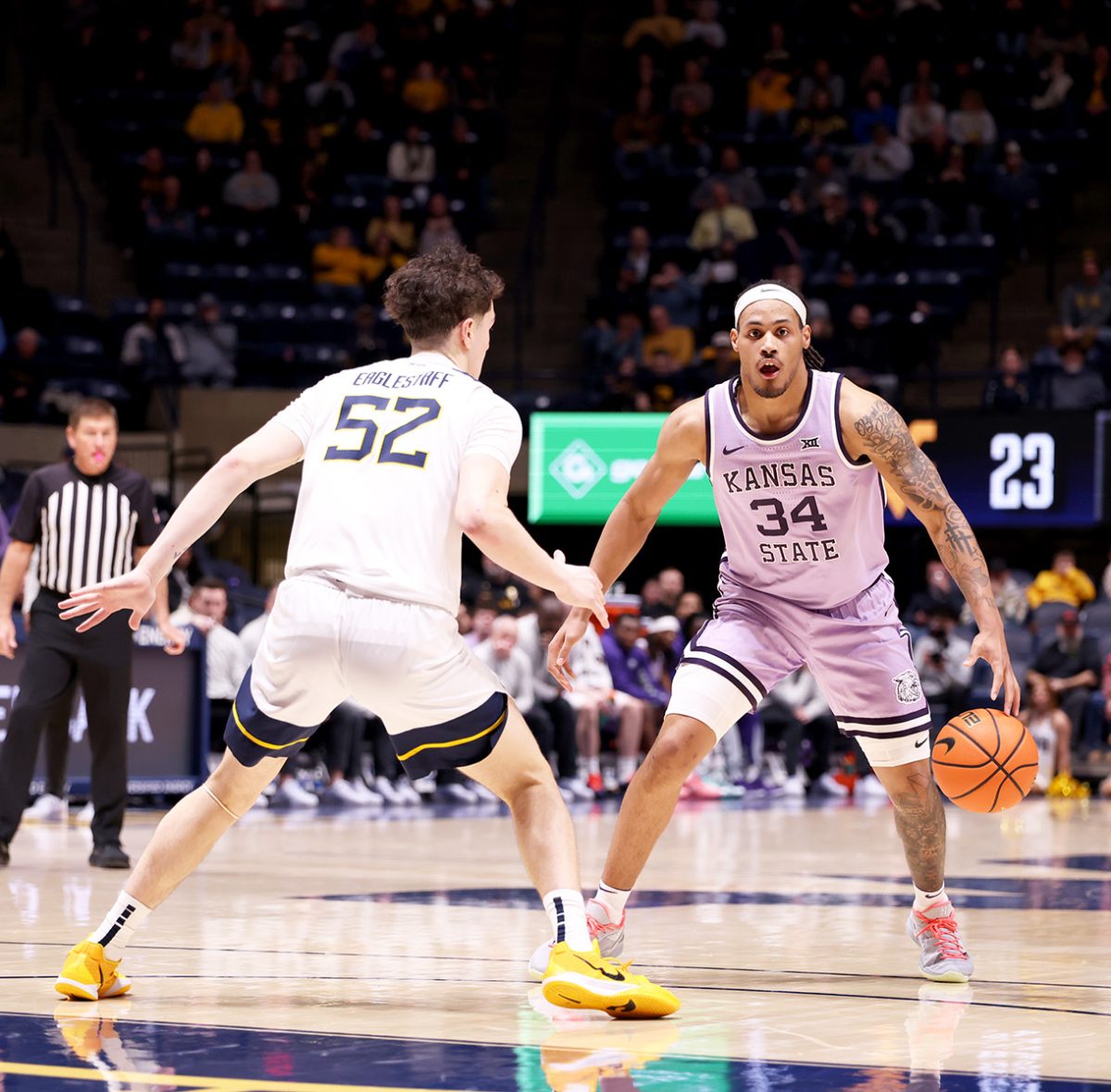 Guard Nate Johnson dribbles the ball at the top of the key against West Virginia. Johnson had 13  points, eight rebounds and four assists against the Mountaineers. The Wildcats lost 59-54.