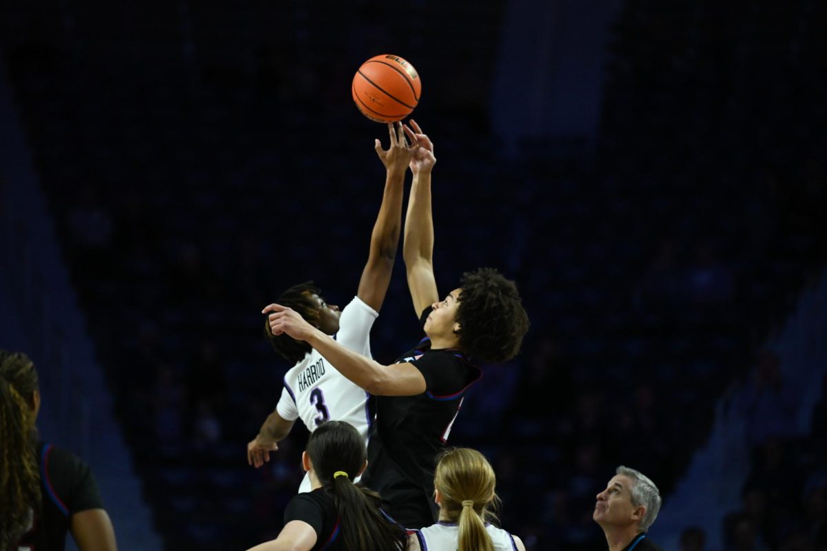 Brandie Harrod goes up for the jump ball to kick off the Sunflower Showdown at Bramlage Coliseum on Feb. 21. 