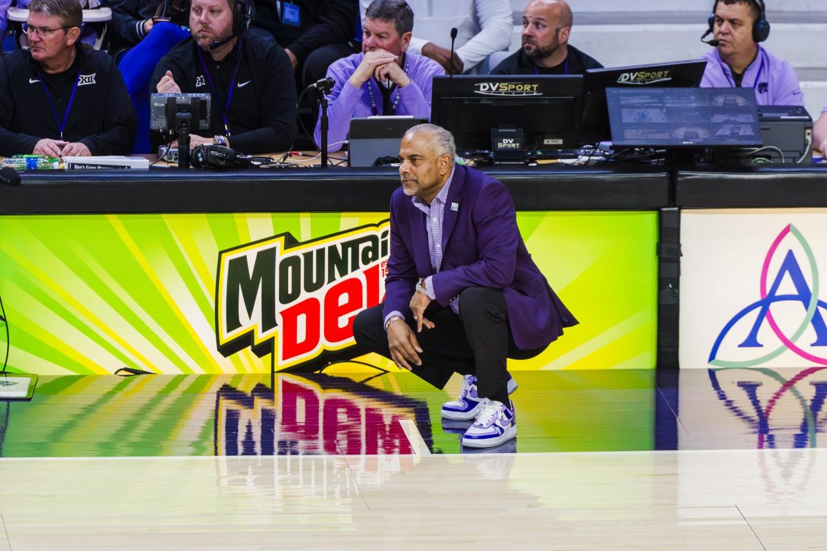 Kansas State head coach Jerome Tang crouches near the sideline watching his defense during the second half against Iowa in Bramlage Coliseum on Feb. 1, 2026.