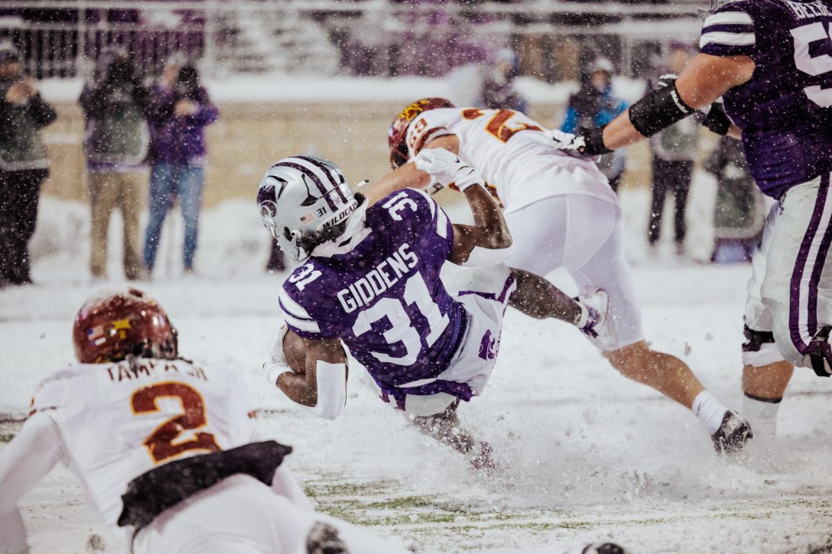 Sophomore running back, DJ Giddons is hit hard by an ISU defensive player.  The Wildcats were taken down by Iowa State 42-35 on Nov. 25,2023 in Bill Snyder Family Stadium. (Archive by Julia Smith)