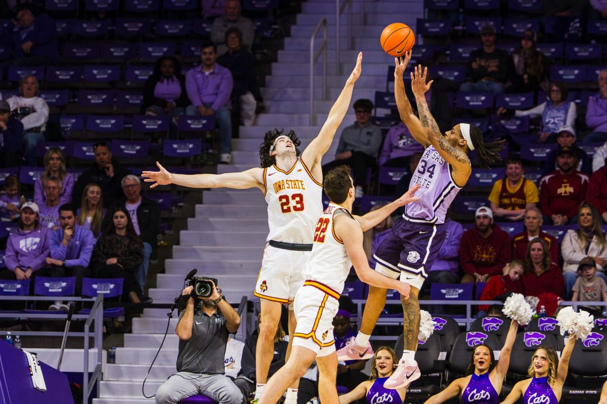 Nate Johnson (34) rises for a three-point shot as a defender leaps to attempt to block shot during the second half of the matchup against Iowa State on Feb. 1. 