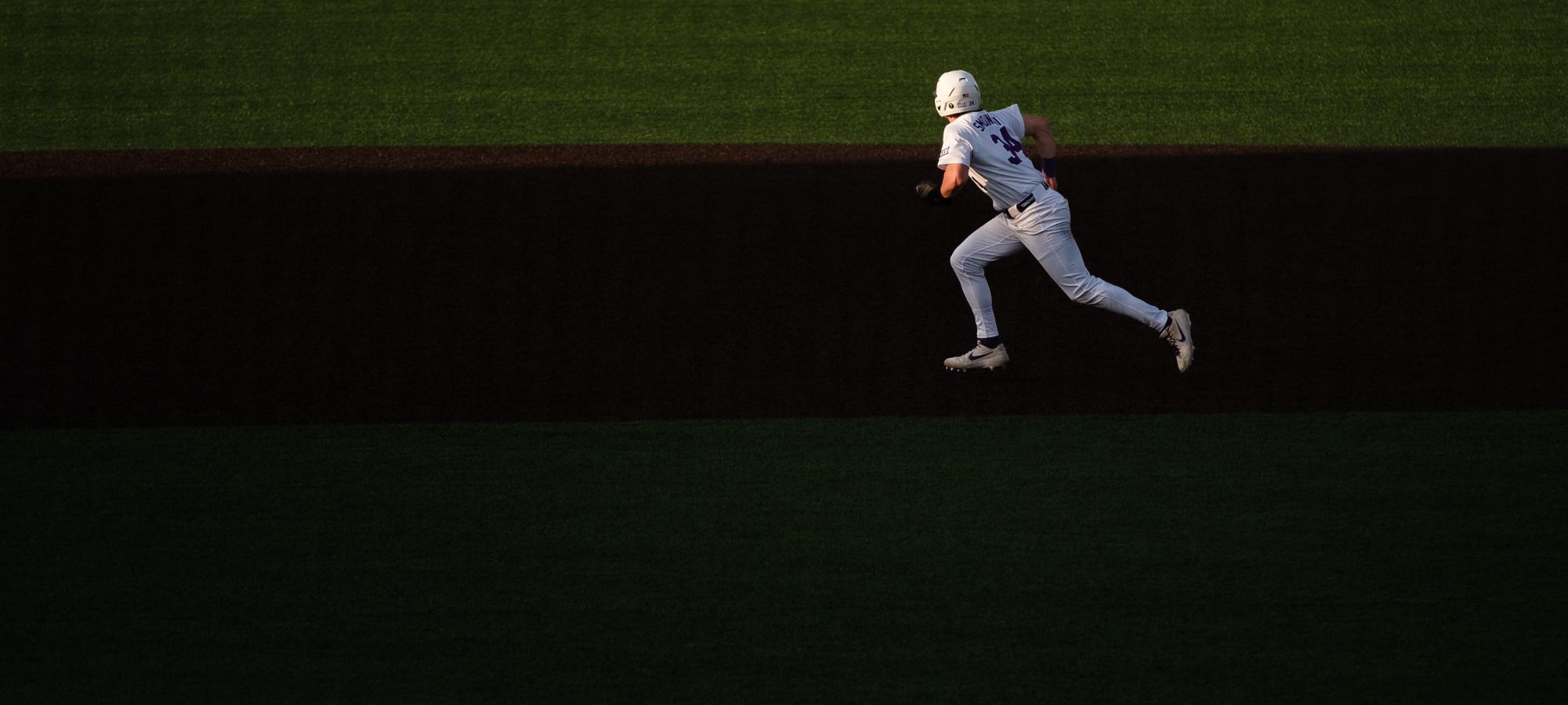 First Baseman Ty Smolinski (34) sprints between second and third base as a runner during the March 6 game against SIUE at Tointon Family Stadium. 