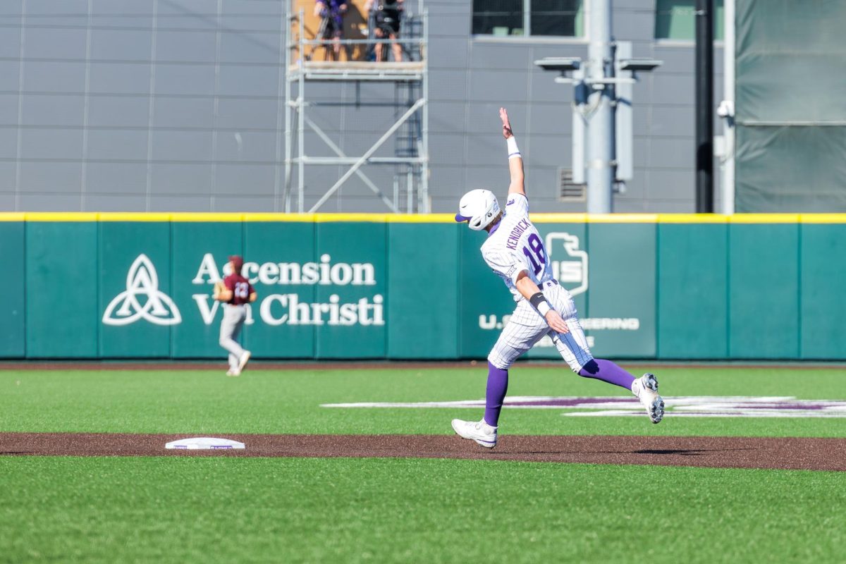 Micah Kendrick (18) heads around second base cheering Shea McGahan’s home run during Kansas State’s matchup with Arizona State University on March 21. 