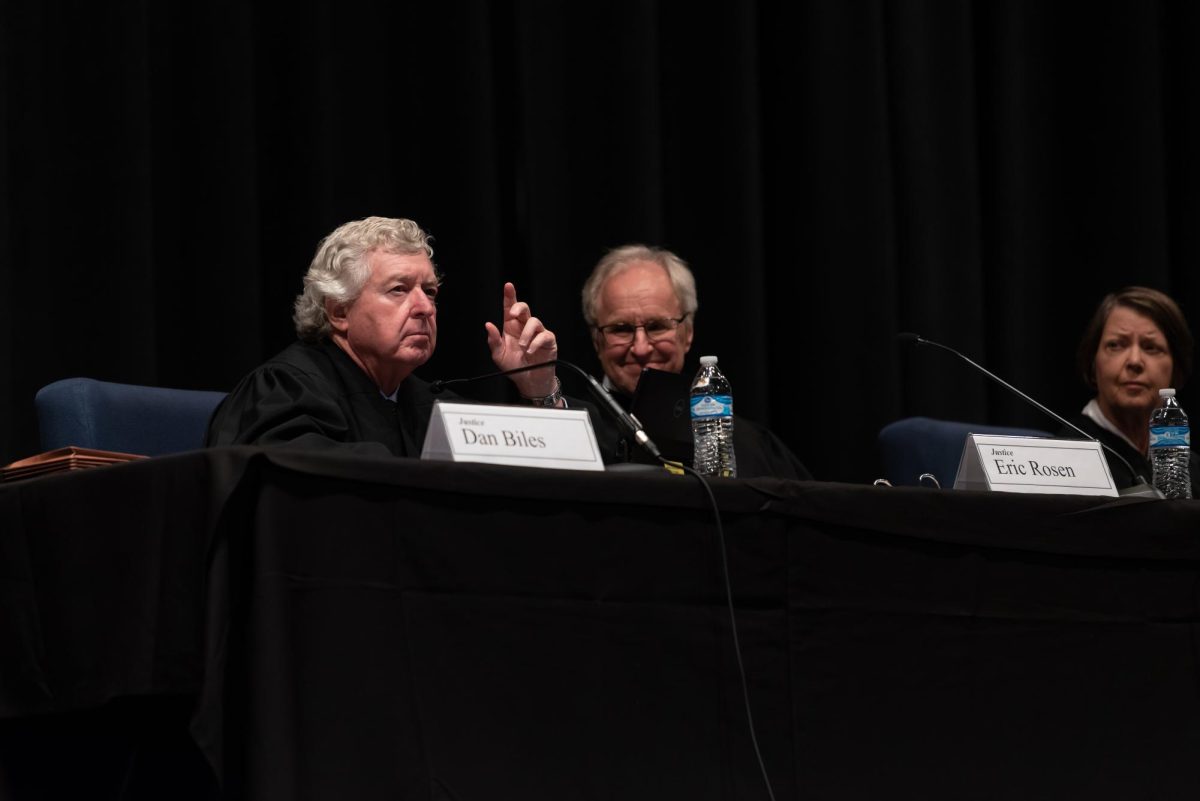 
Kansas Supreme Court Justice Dan Biles waves to the audience located in Manhattan High School's auditorium after being introduced by Chief Justice Lawton Ness on Sept. 24, 2018.