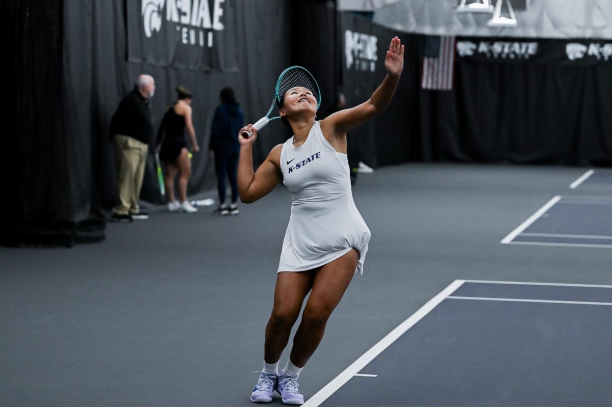 Junior Maralgoo Chogsomjav reaches up to serve to West Virginia's Audrey Moutama. Maralgoo faced tiebreakers in both sets and battled to secure a victory over Moutama in the no. 1 spot. 
