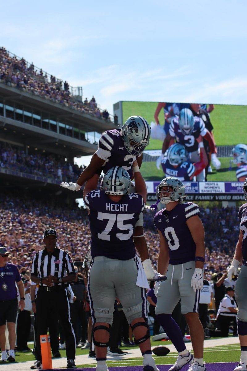 Sam Hecht lifts Dylan Edwards into the air celebrating a play by Edwards during their game against UCF. The Wildcats rose to victory at home on Sept. 27, 2025.