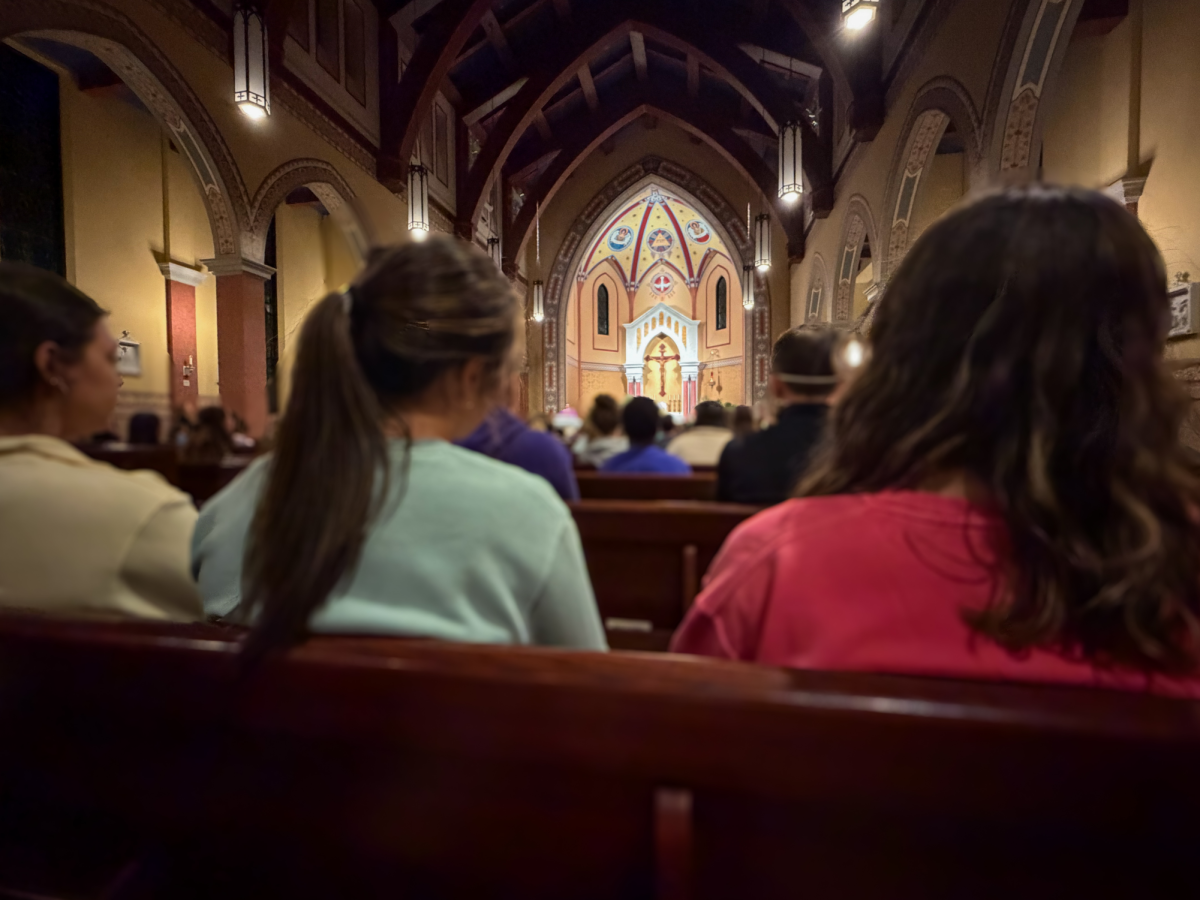Students and community members gather at St. Isidore’s Catholic Student Center on March 31 at 9:09 p.m. to celebrate daily mass. The center provides a consistent space for spiritual growth as it prepares to welcome 92 new converts, a 122% increase in participation, during this Saturday's historic Easter Vigil.