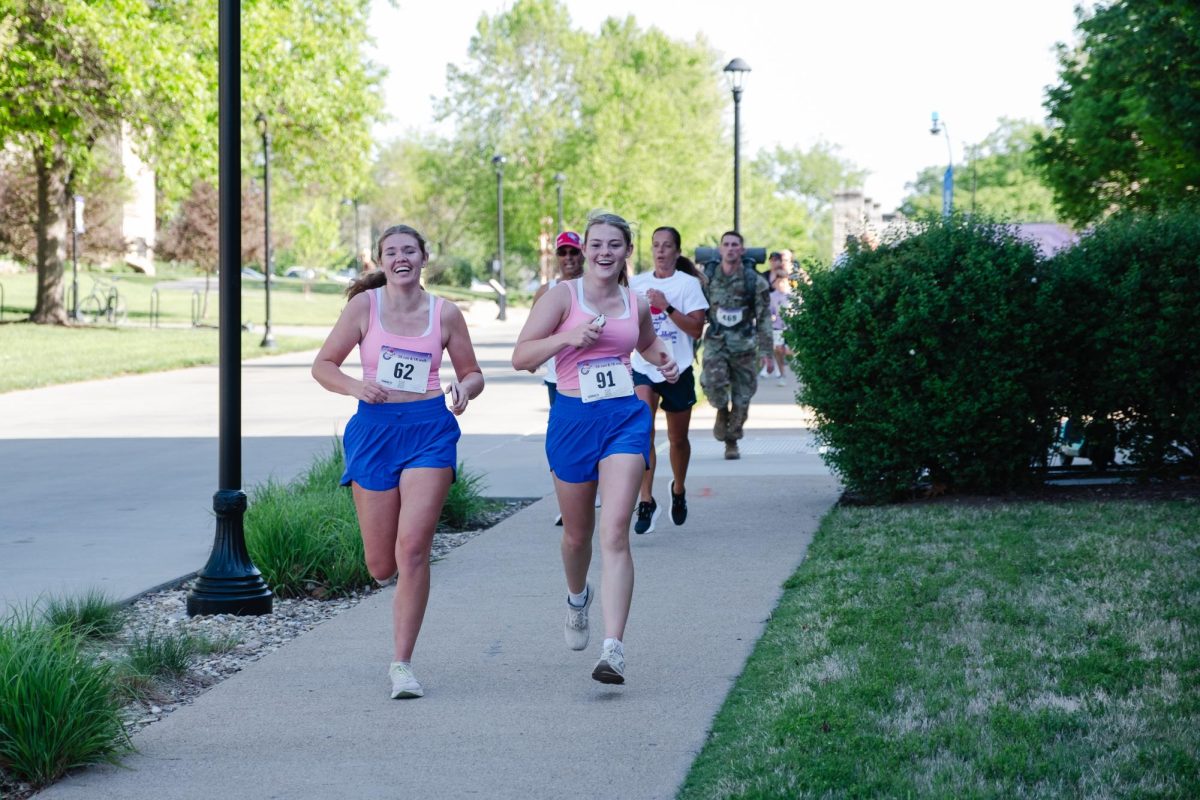 Two women participating in the annual Run for the Roses laugh as they trot along the Martin Luther King Jr. walkway on April 25. 