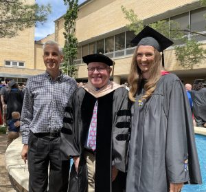 David Pickering, professor of organ and music theory and associate director for music at K-State [left], and James Higdon,  professor of organ and director of the division of organ and church music at the University of Kansas [middle], stand with Audrey Pickering [right] at her graduation from the University of Kansas. Both David and Audrey Pickering studied organ under Higdon. (Photo Courtesy of David Pickering)