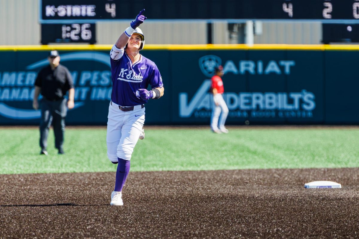 Designated hitter Micah Kendrick (18) points toward the stands while rounding second base after hitting a home run during the Wildcats’ 20–7 win over SIUE on March 8. 