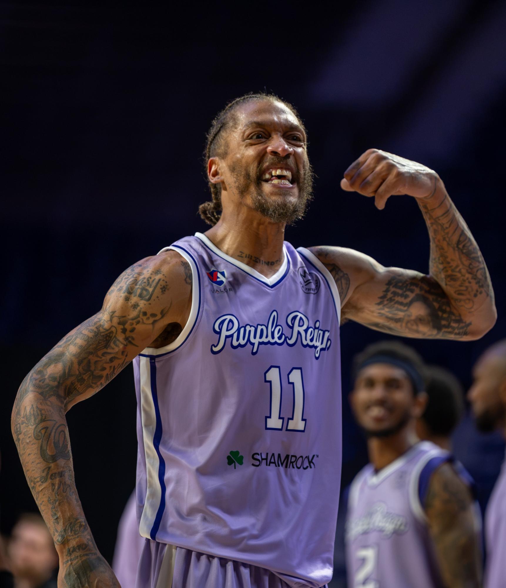 Michael Beasley (11), Purple Reign forward, flexes and smiles toward the crowd after exchanging words with the JHX Hoops bench.