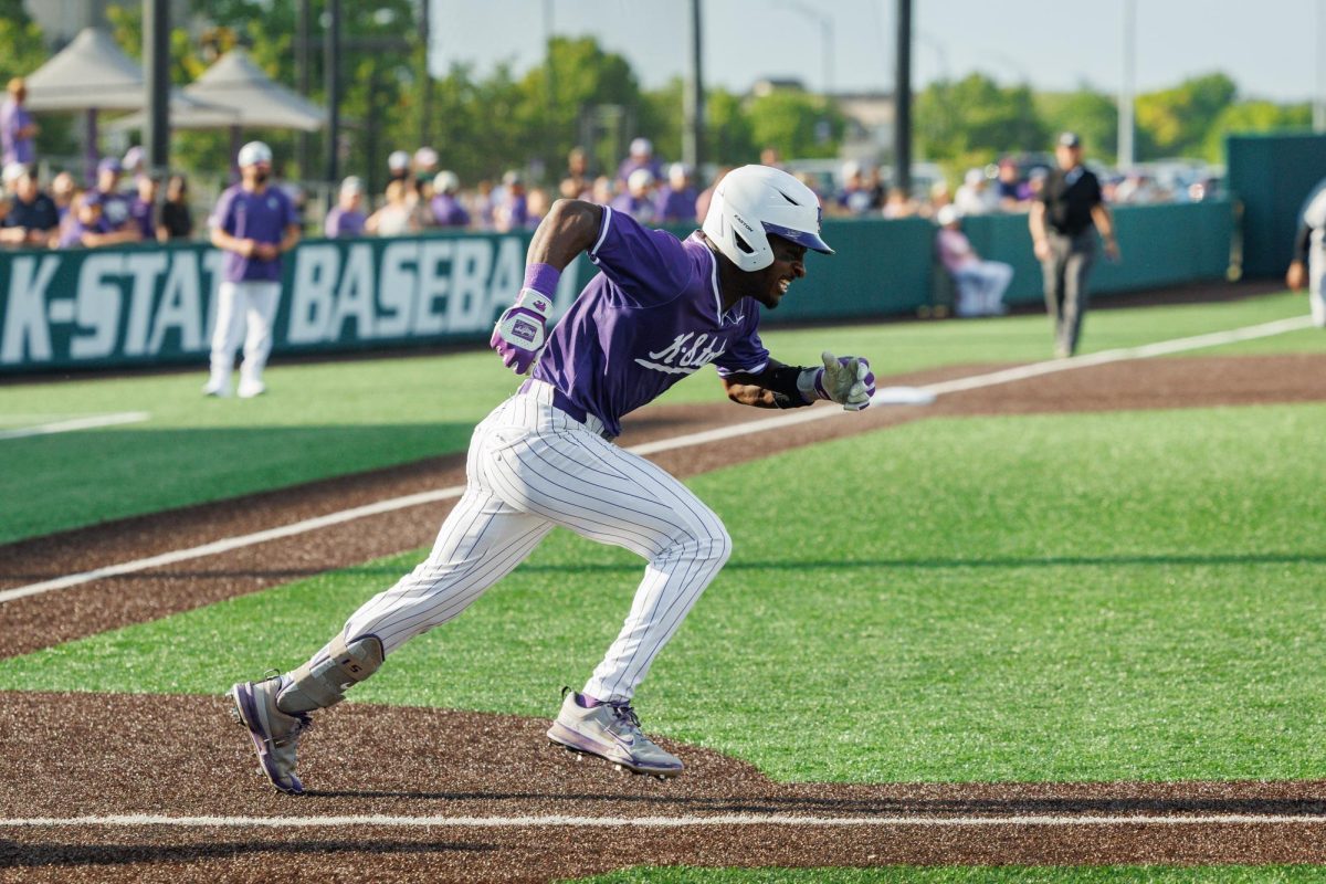 Dee Kennedy races toward first base during the Kansas State Wildcats' matchup against the Cincinnati Bearcats on May 9. 