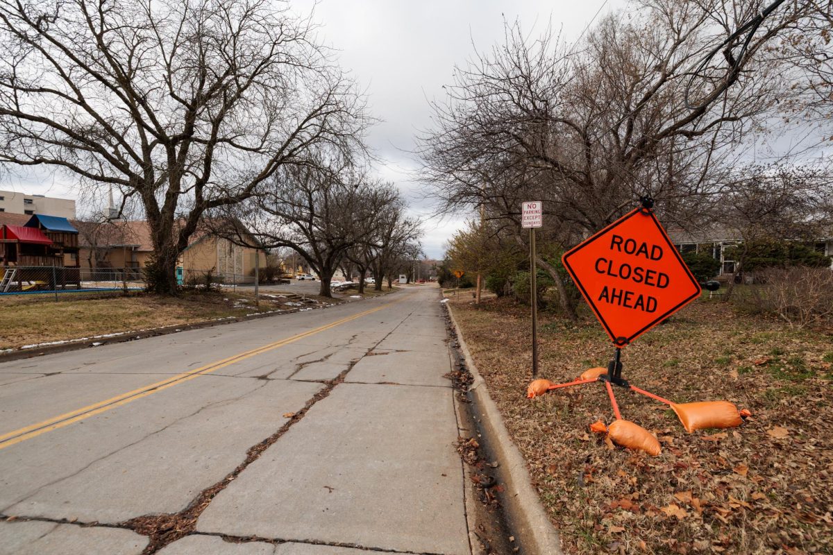 A orange road sign on the side of College Heights road facing towards Anderson Avenue in Manhattan, Kan, on Dec. 3, 2025. 
