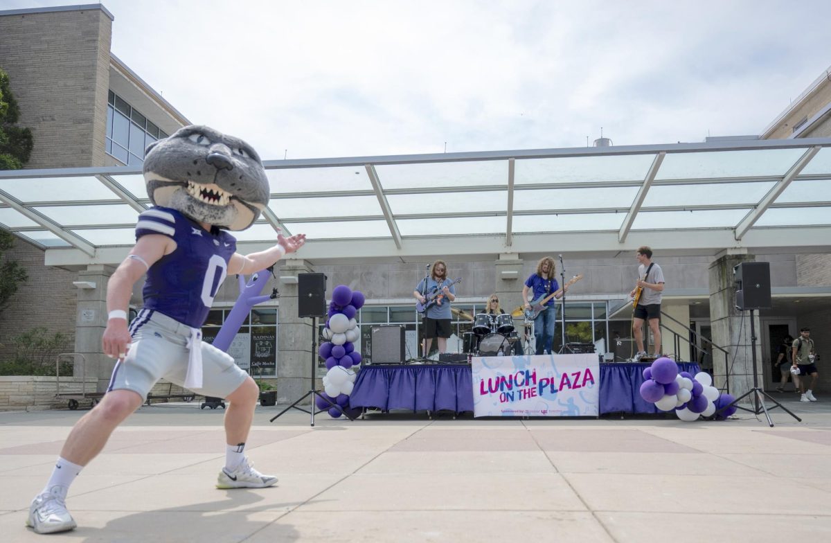 Willie the Wildcat points toward the Band Manhattan Project during K-State’s Week of Welcome lunch on Bosco Plaza in Manhattan, Kansas, on Aug. 26. 