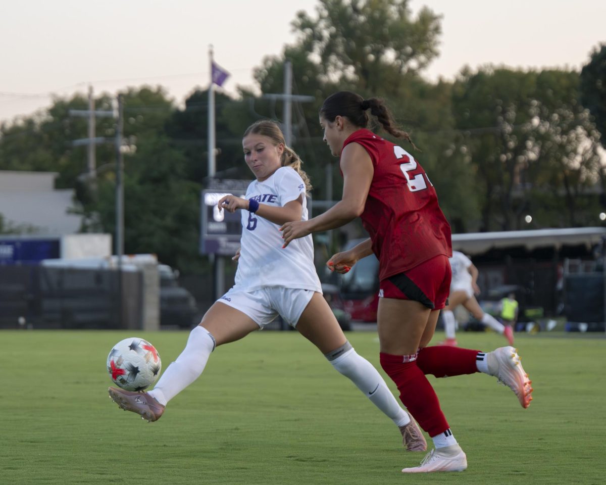 Kansas State senior Rilyn Rintoul(6) gathers the ball as she tries to navigate around an oncoming Nebraska defender during the Wildcats’ senior night match against Nebraska on Aug. 30. Rintoul played 74 minutes in the match.