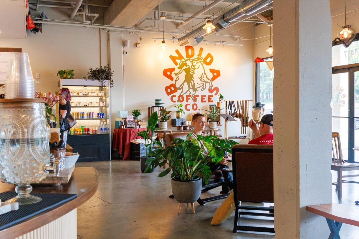 Customers sit inside the newly opened Bandidas Coffee Co, in the open seating area and a full retail display alongside its main service area.