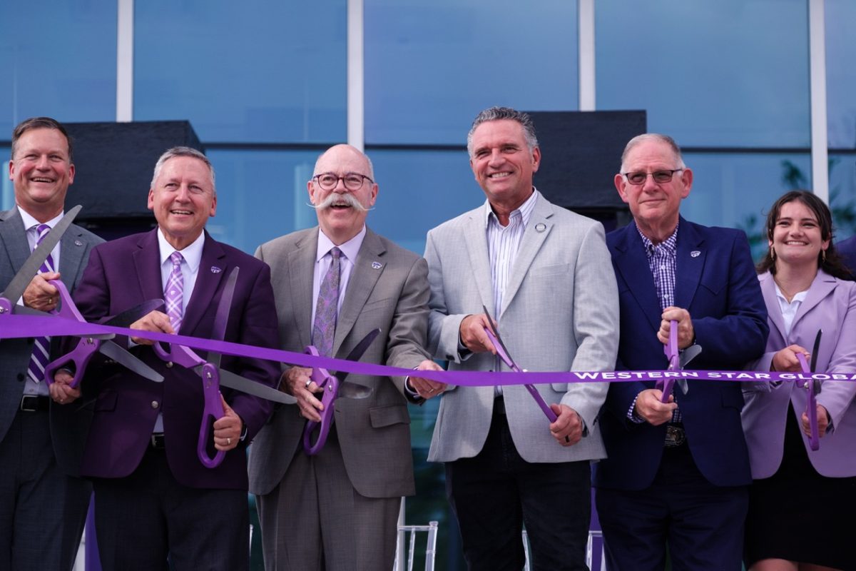 Representatives from K-State and the College of Agriculture, including Dan Moser, Dean of Agriculture and President Richard Linton pose before slicing the ribbon to celebrate the opening of the Western Star Global Grain and Food Center on Sept. 18.