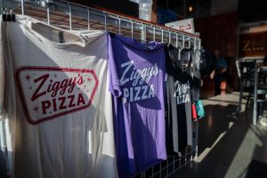 Shirts hang for sale inside of the newly opened Ziggy's Pizza in Manhattan.