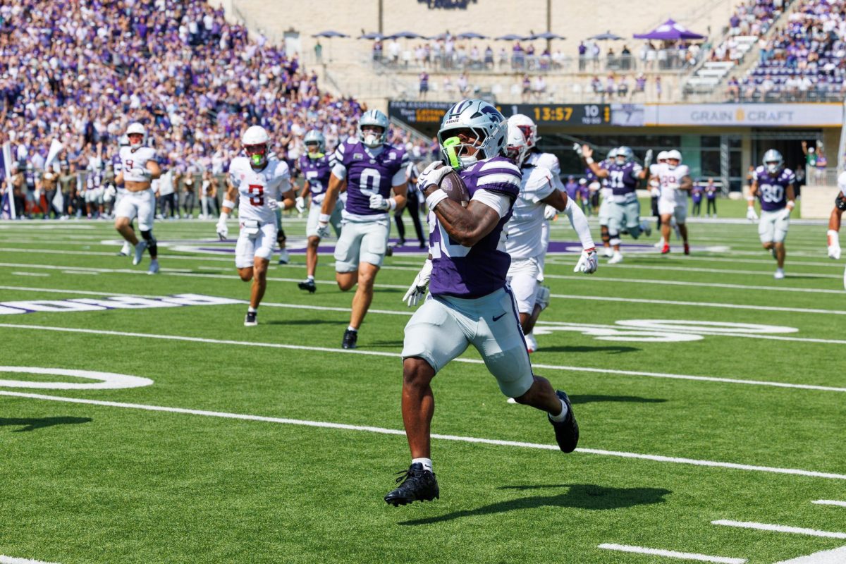 Kansas State running back Rodney Fields Jr. (20) accelerates downfield into the open turf to score a 75-yard touchdown. Fields capped off the 34-7 win with 105 net rushing yards and one score on Sept. 12.