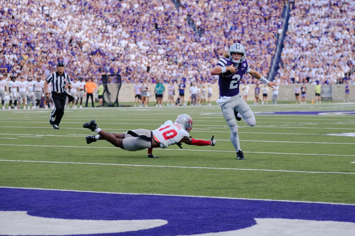 Quarterback Avery Johnson (2) breaks a tackle before bursting into the endzone for a touchdown against Nicholls on September 5. K-State's potent offense would drop ten touchdowns in the 71-3 victory to debut the 2026 season. 
