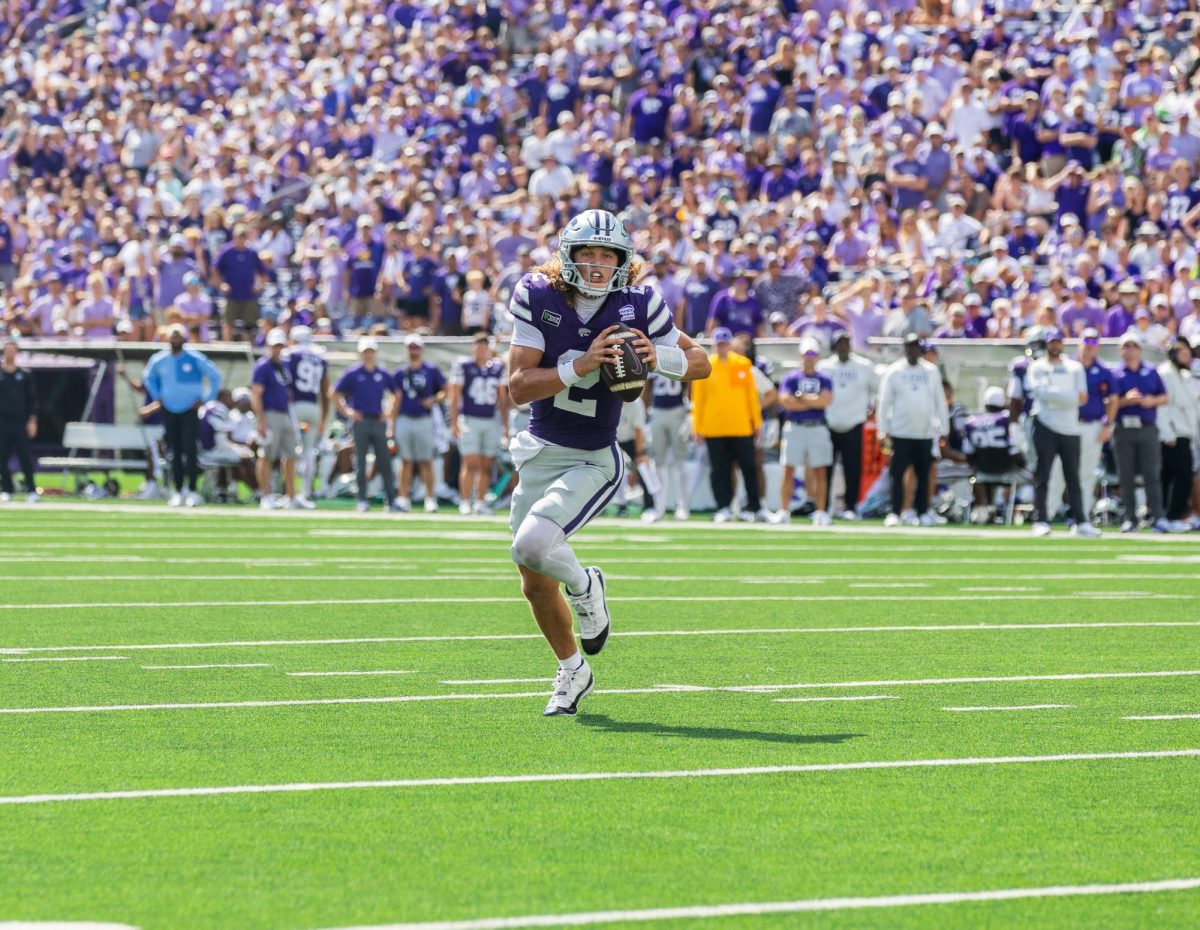 Avery Johnson looks toward the end zone for an open route to run. Johnson threw for 227 passing yards, 152 rushing yards and two rushing touchdowns. This made Johnson the first player in K-State history with 200 passing yards and 150 rushing yards in a single game. 